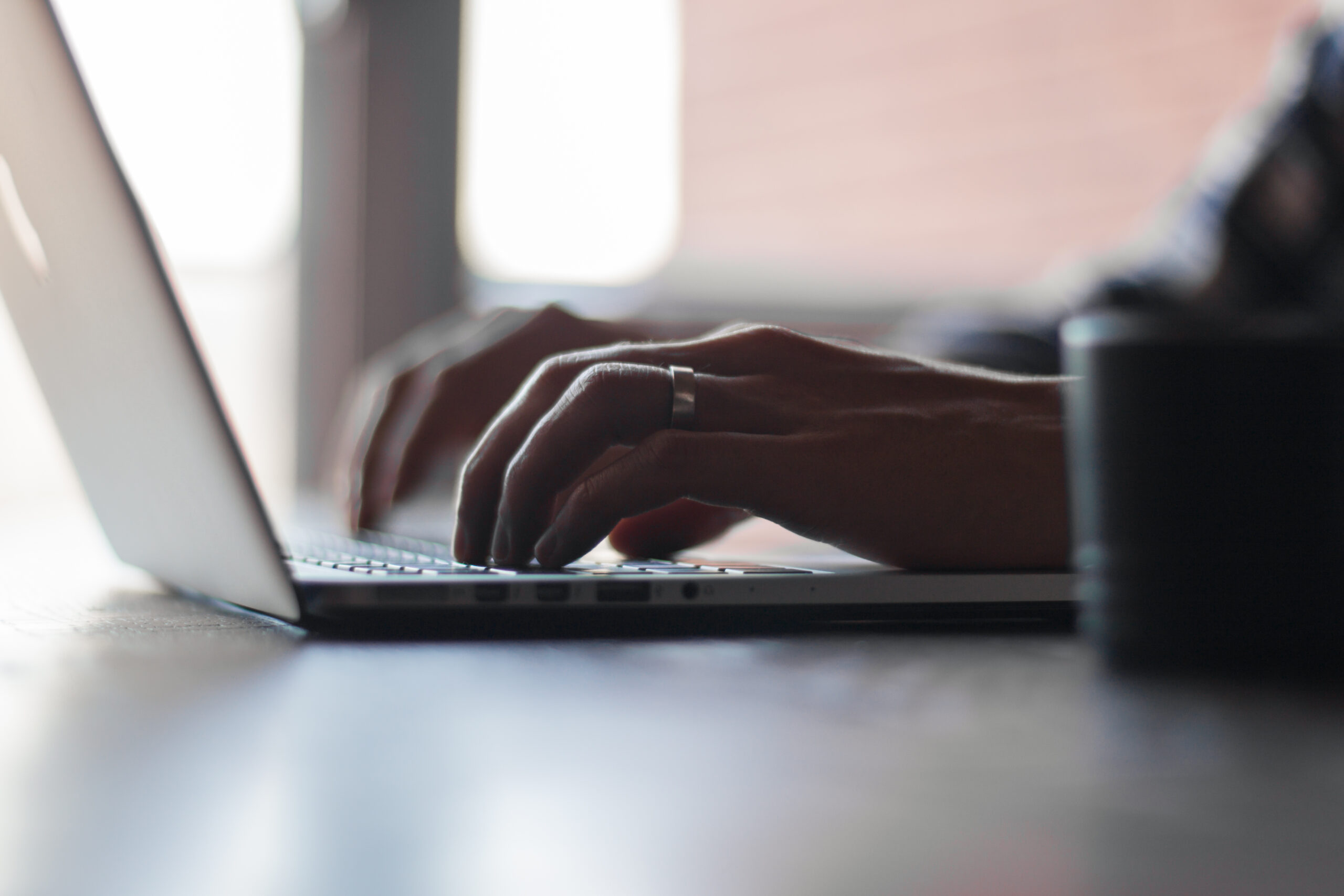 Hands typing on a laptop keyboard, similar to using ChatGPT Work on desktop