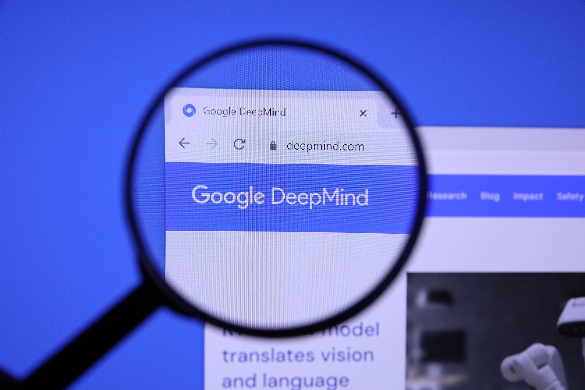 Google DeepMind website homepage magnified with a magnifying glass