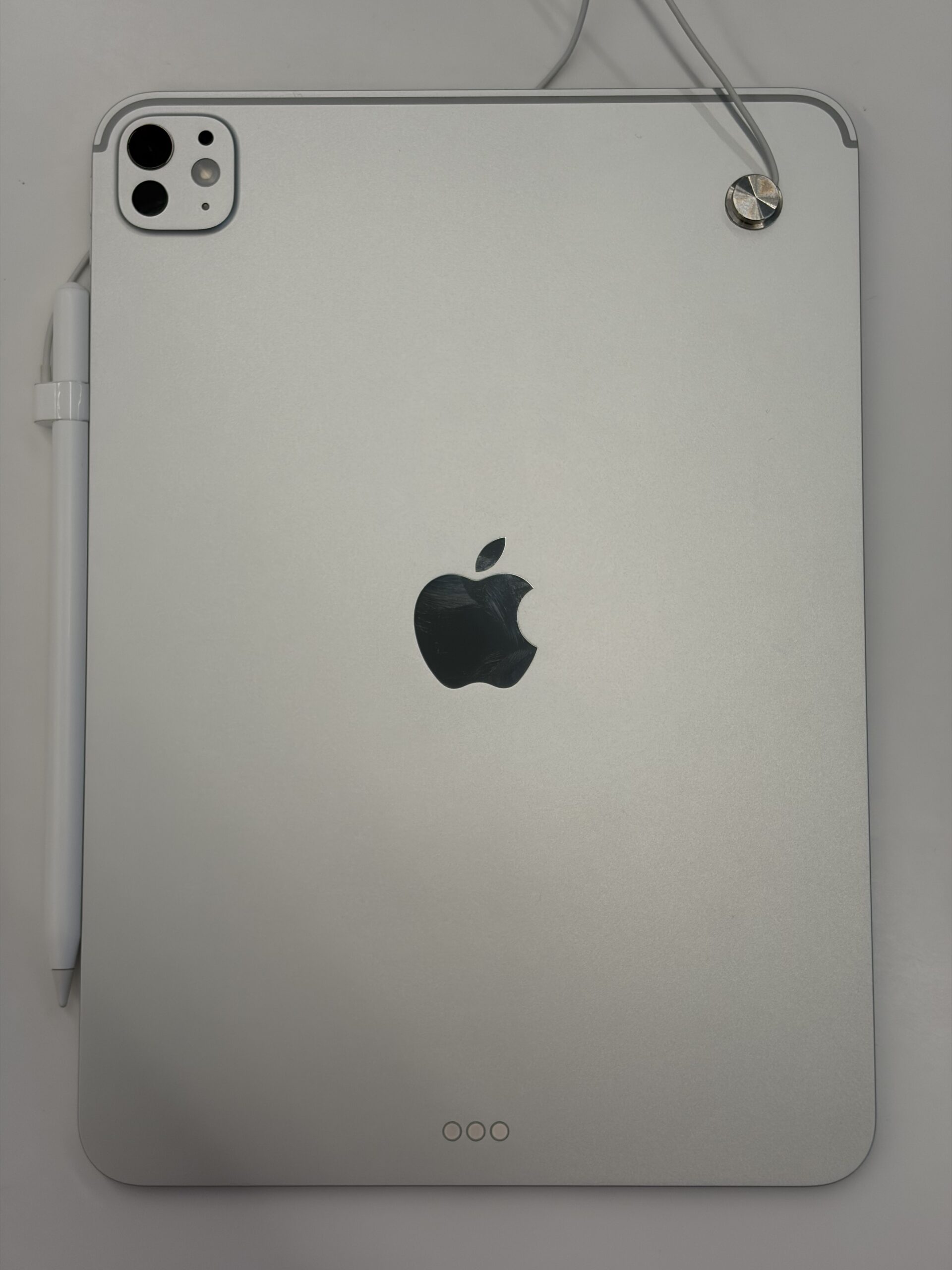 Apple Pencil attached to the magnetic edge on the back of an iPad Pro