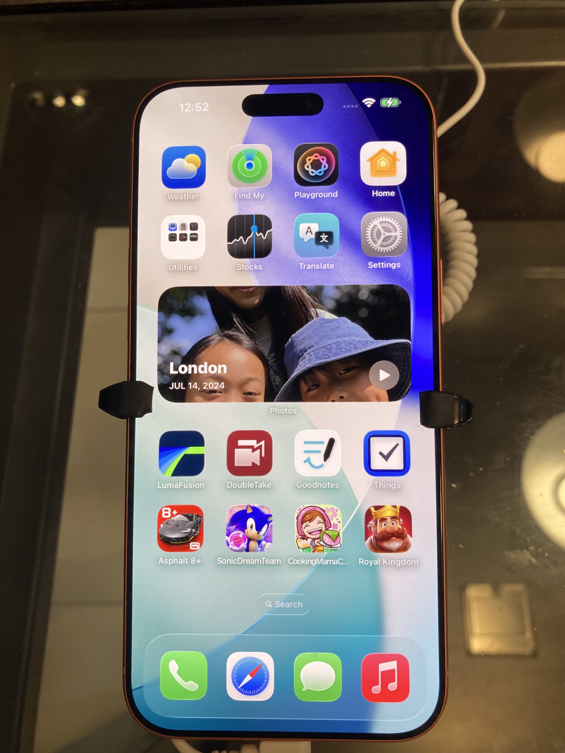 iPhone home screen with the green Messages icon visible in the dock
