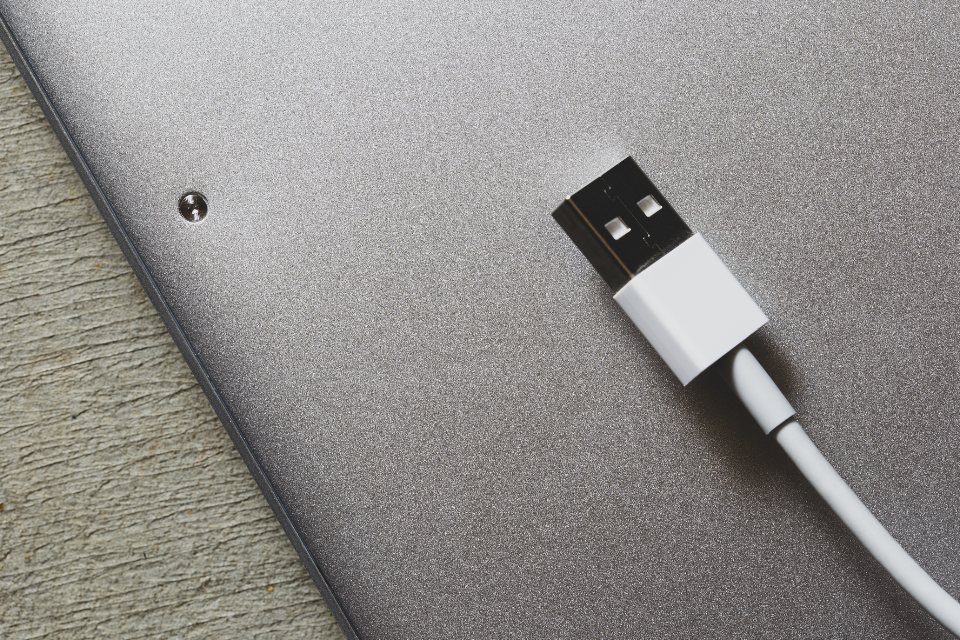 Charging cable plugged into the side of a laptop, the kind of connection affected by an 80 percent battery charge limit