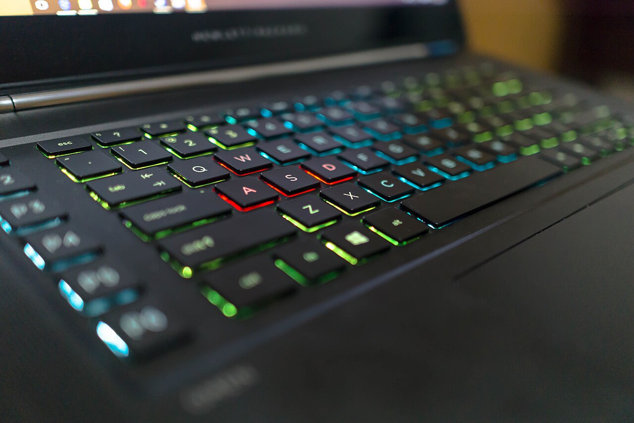 Close-up of a backlit laptop keyboard with colorful RGB lighting