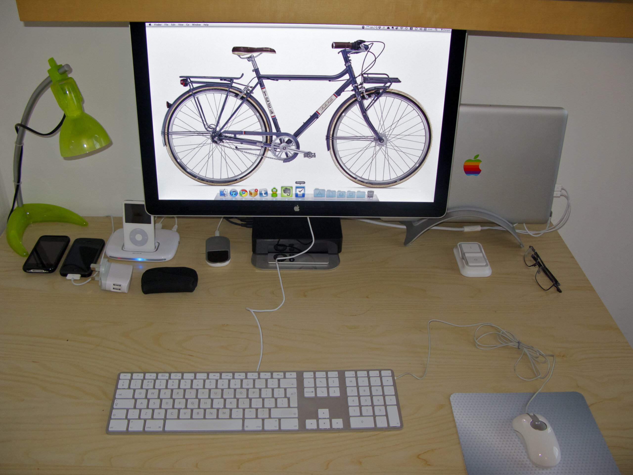 Mac laptop workspace where iCloud Drive uploads run in the background