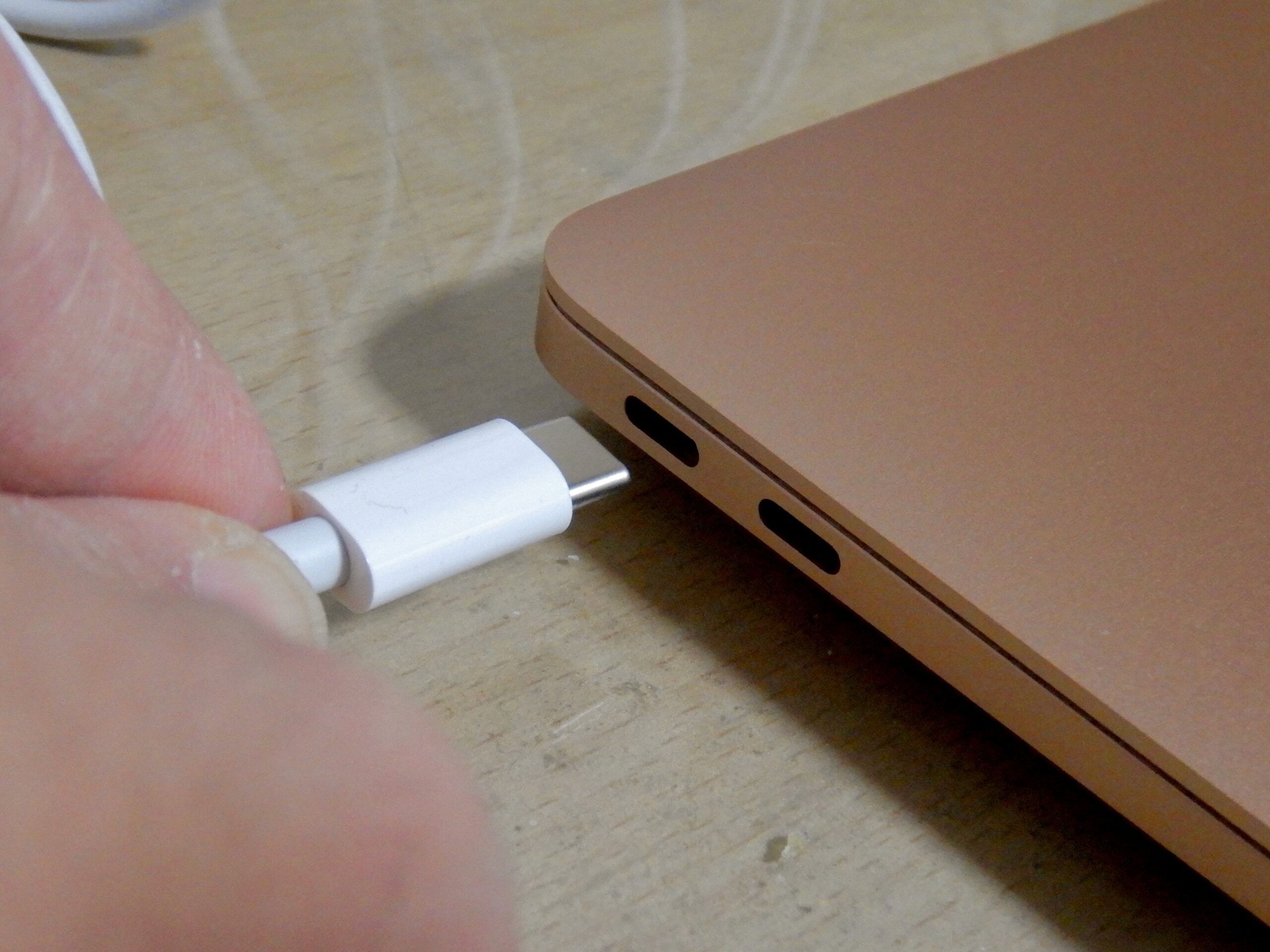 USB-C cable being connected to a MacBook Air port for a wired data transfer