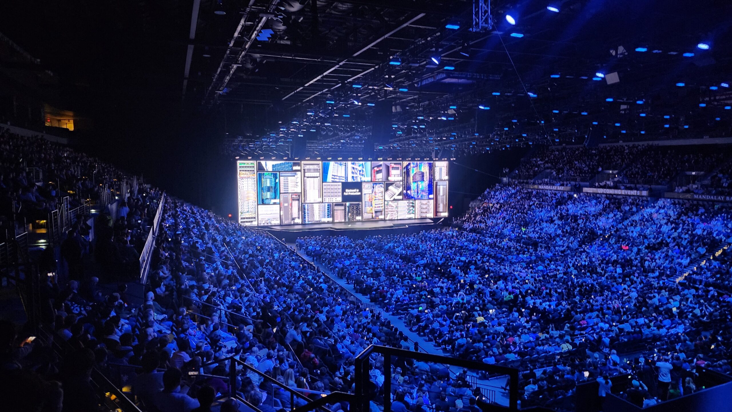 Crowd at an AI hardware keynote showing the scale of the AI compute race