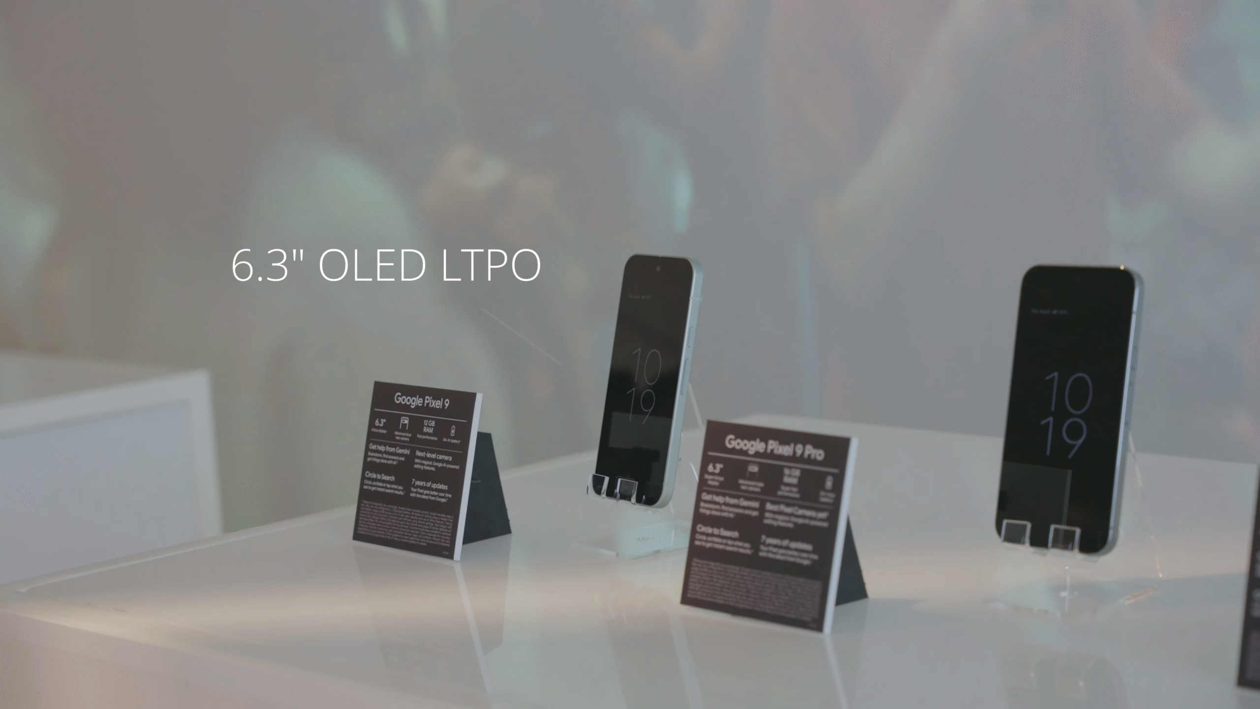 Google Pixel 9 and Pixel 9 Pro on display stands with spec cards in a retail store