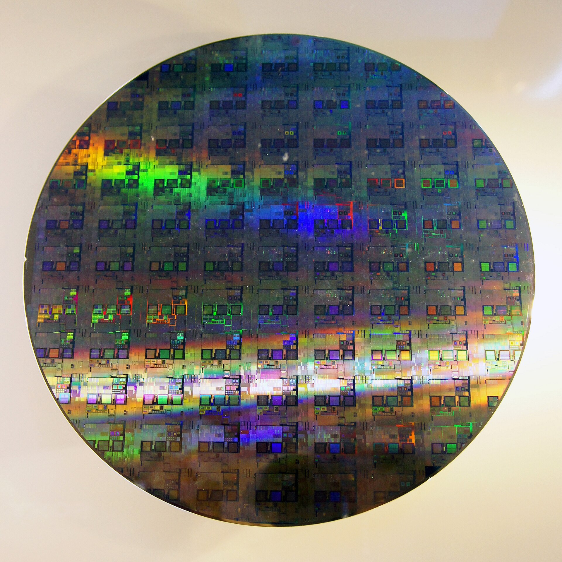 Close-up of a silicon wafer with chip dies, representing the 2-nanometer manufacturing process